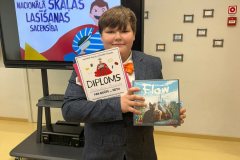 Rolands ar diplomu par iegūto 2. vietu skaļās lasīšanas sacensībās un filmas "flow" disku